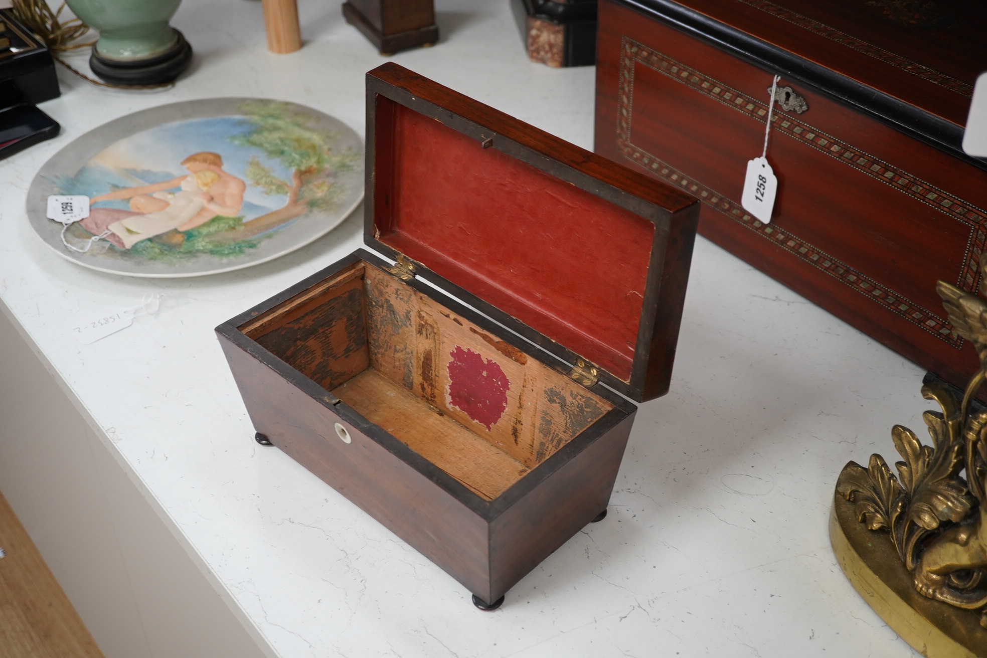 A Victorian mahogany sarcophagus shaped tea caddy with mother of pearl inlaid escutcheon, 28cm. Condition - fair